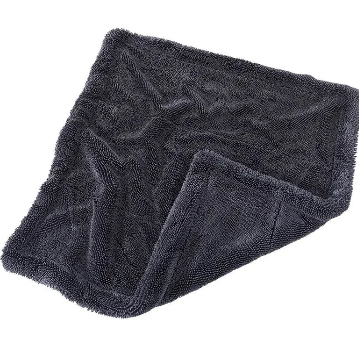 Folded dark gray towel on a white background