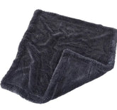 Folded dark gray towel on a white background