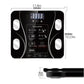 Top view of black BodyIQ™ smart scale with reflective tempered glass and four bio-impedance electrodes